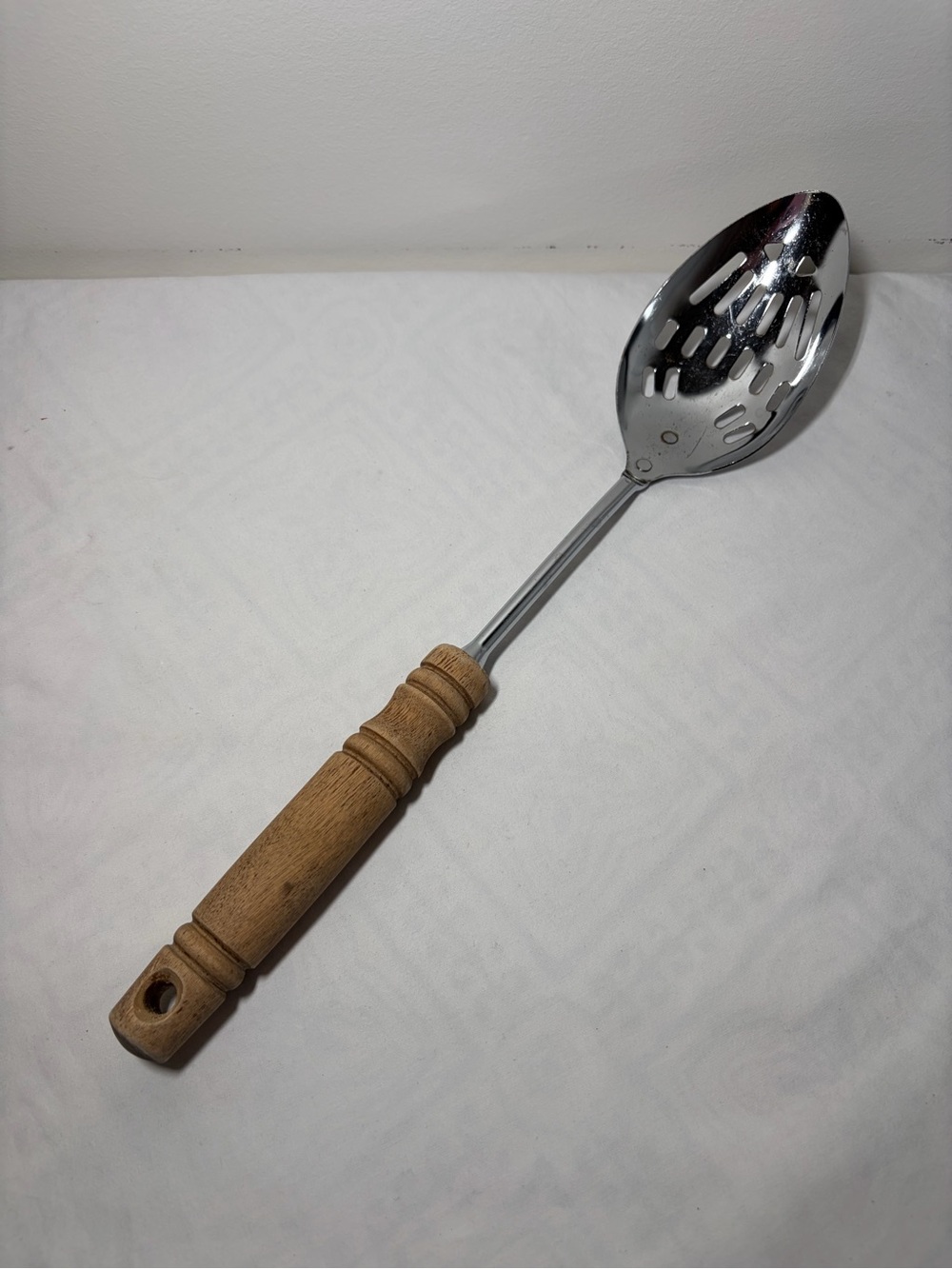 EKCO Stainless Steel Slotted Spoon, Brown Wood Handle, Silver Solid Pattern